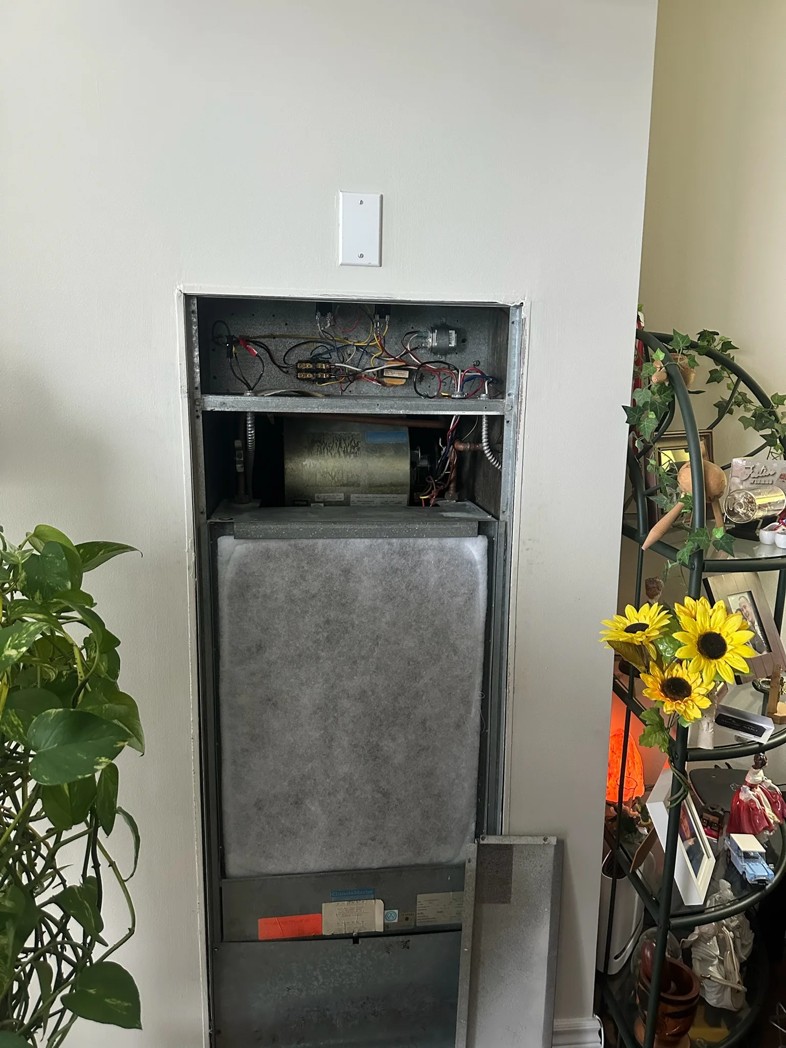 Condo fan coil unit opened for service with a new filter