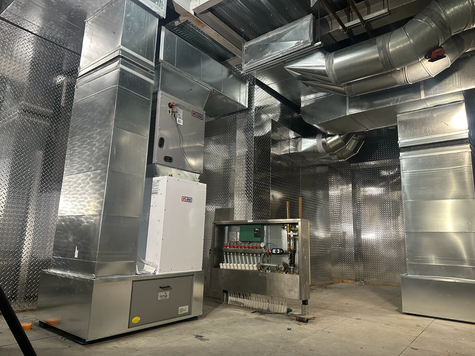 Custom galvanized ductwork and iFlow air handler installed in a mechanical room