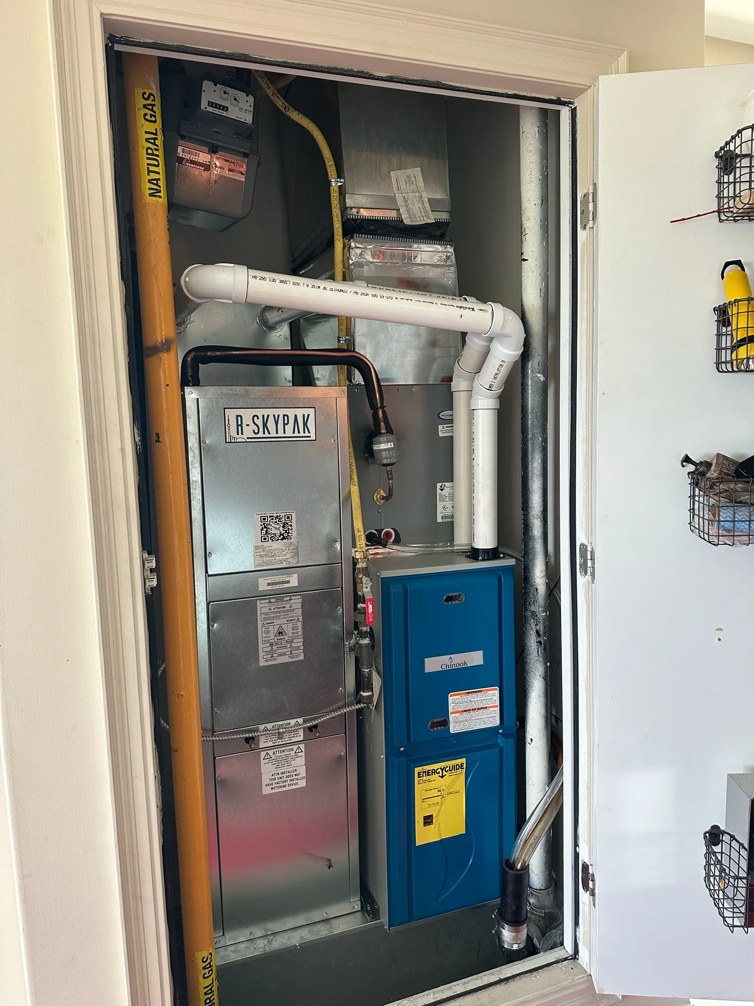 In-suite R-Skypak heat pump and Chinook furnace installed in a condo mechanical closet