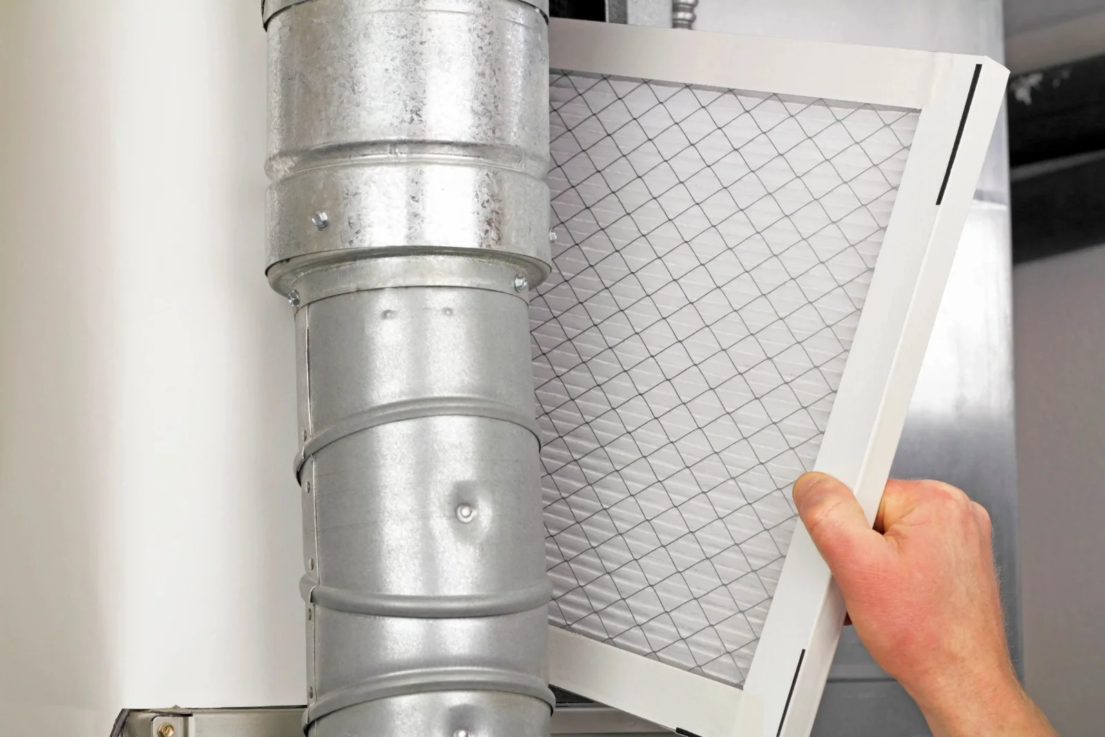 Technician replacing a high-efficiency furnace air filter