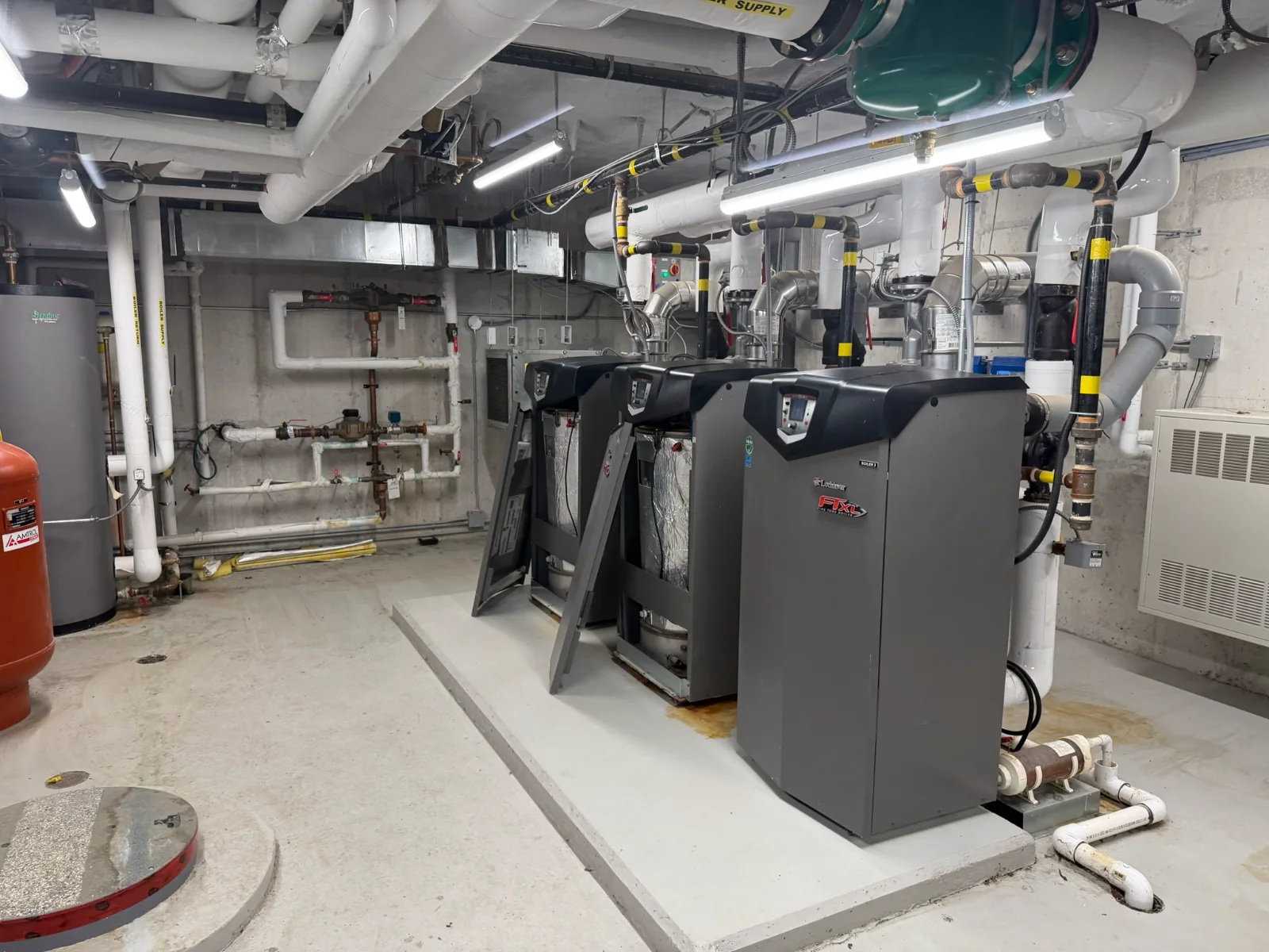 Three Lochinvar FTXL fire-tube boilers installed in a commercial boiler room