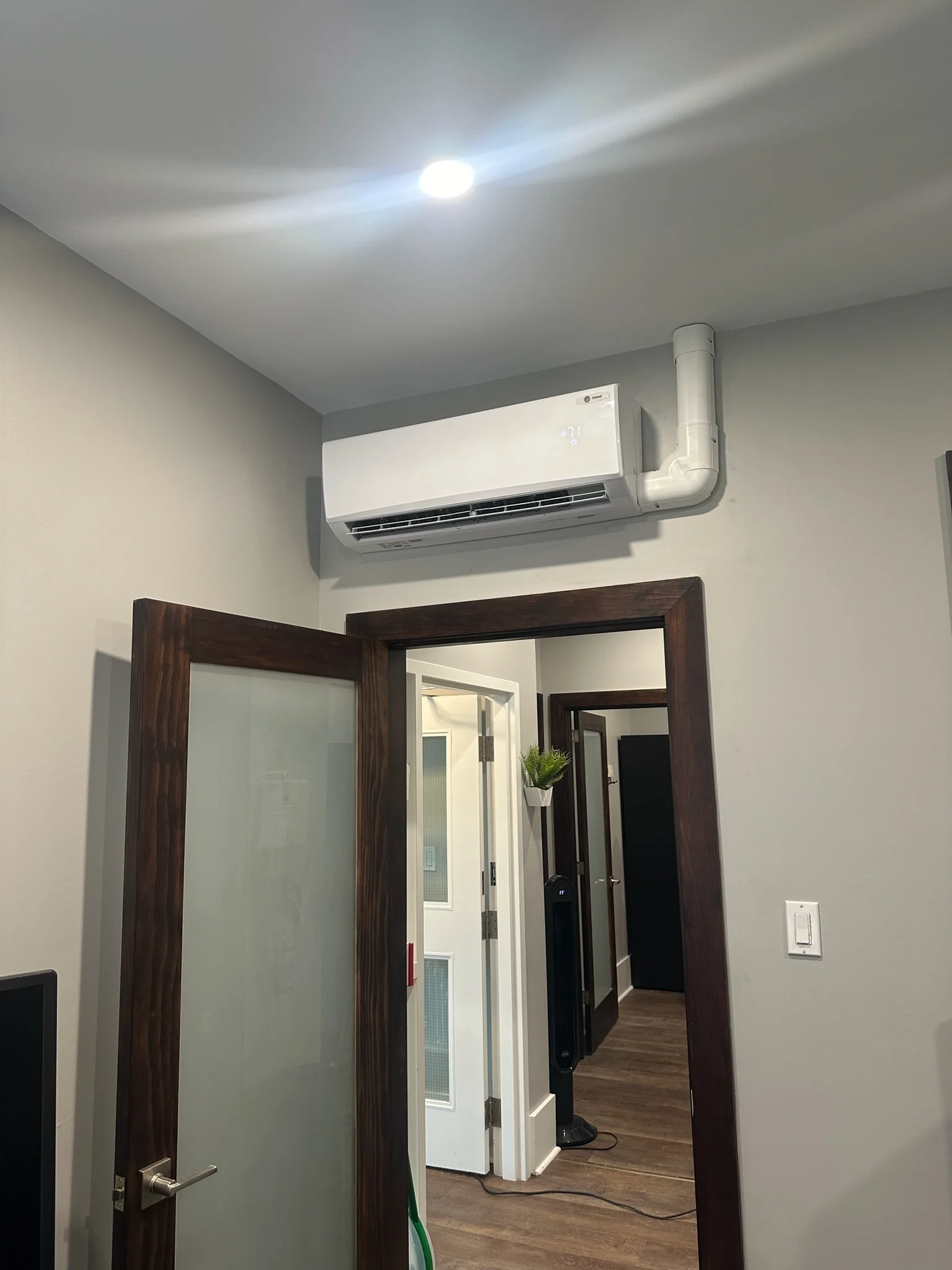 Trane ductless mini-split head mounted above a doorway