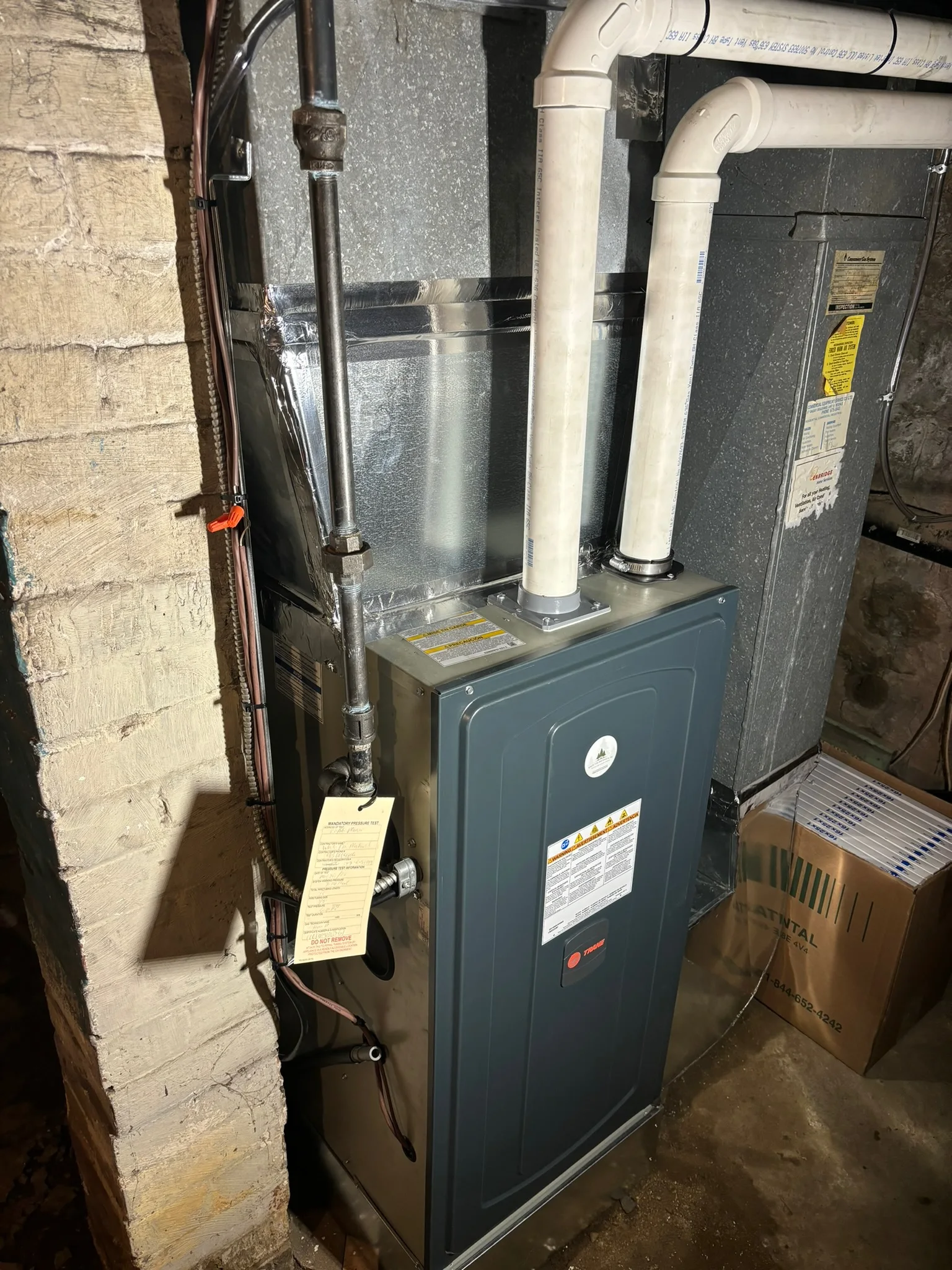Trane furnace with a gas pressure test tag signed off by White Pine Mechanical